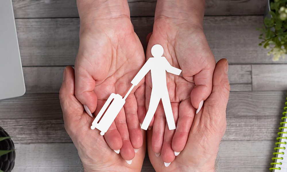 Blog - Paper Person Walking with Suit Case Held Within Man and Woman Hands