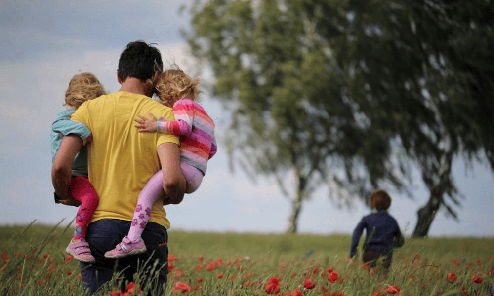 4 Must Have Insurance Policies For Everyone - Man Holding 2 Kids